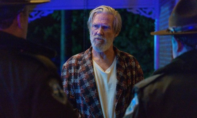 Jeff Bridges in The Old Man staring at two people at his doorstep.