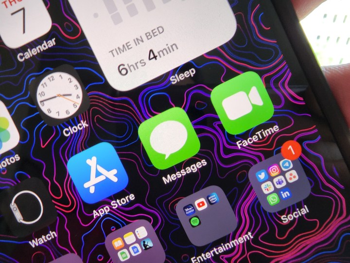 Apple Messages icon on iPhone display.
