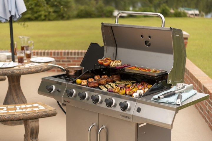 Char-Broil Performance 5-Burner Gas Grill with food on an outdoor patio.