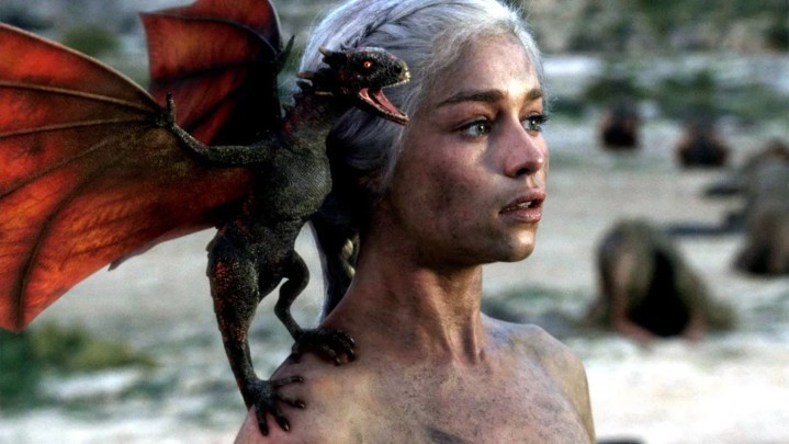 Daenerys emerging from the ashes with baby Drogon on her shoulder.