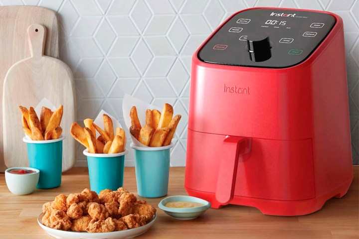 Instant Pot Vortex 4-in-1 2-quart Mini Air Fryer on the counter with fries and chicken.