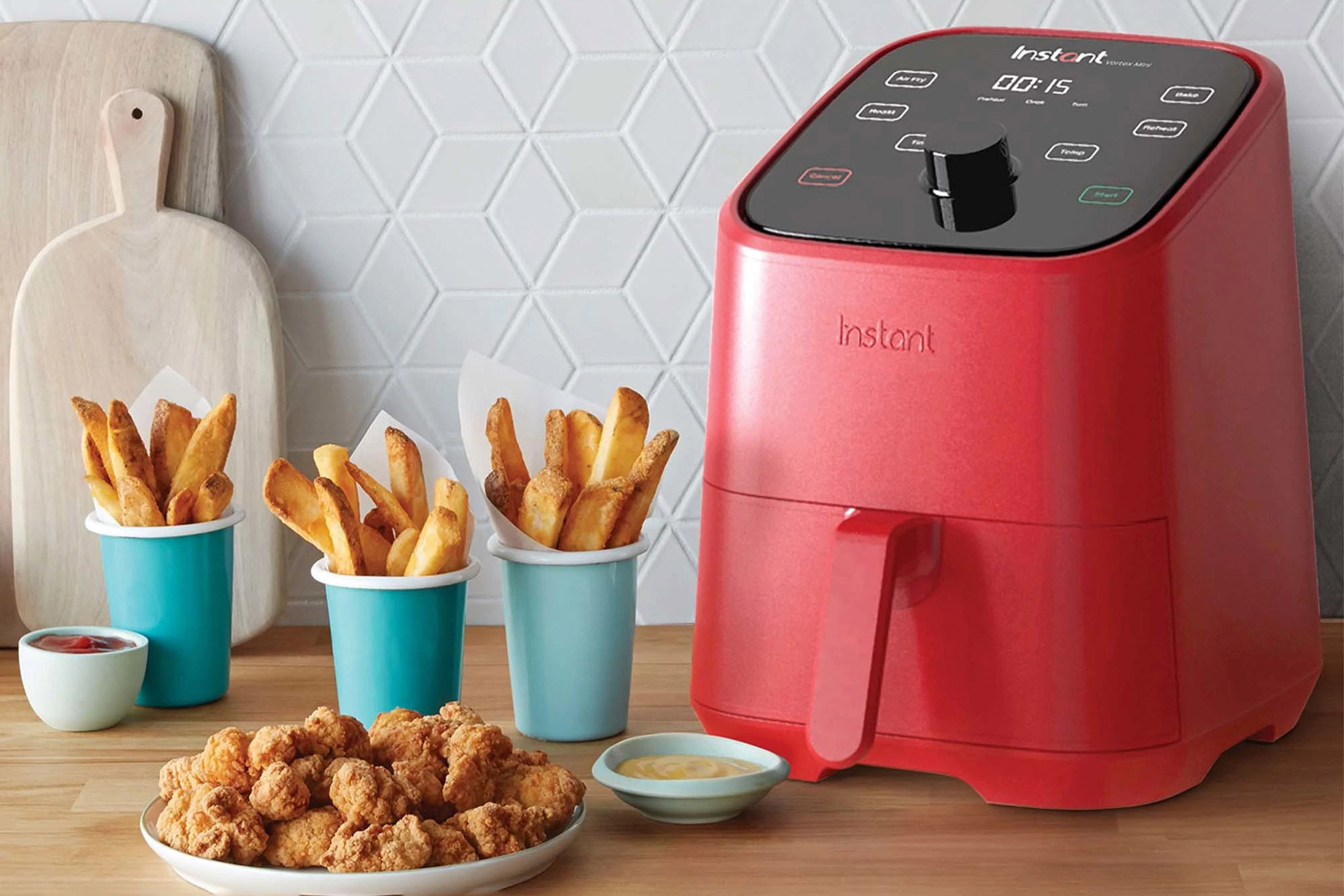 Instant Pot Vortex 4-in-1 2-quart Mini Air Fryer on the counter with fries and chicken.