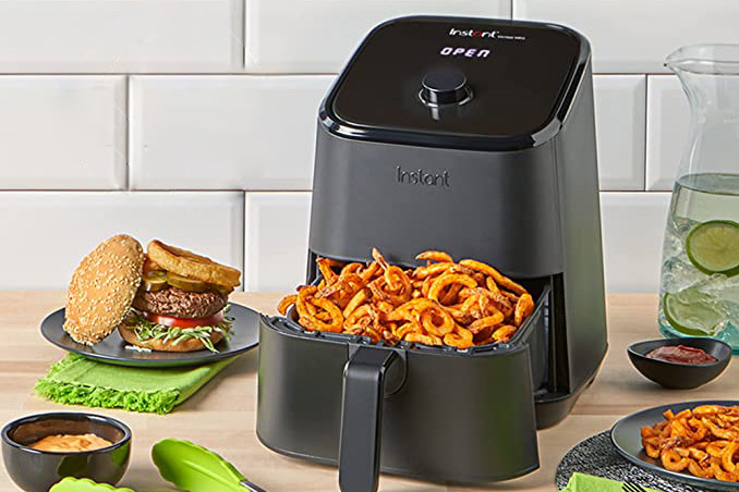 Instant Pot Vortex 4-in-1 2-quart Mini Air Fryer on the counter filled with curly fries.
