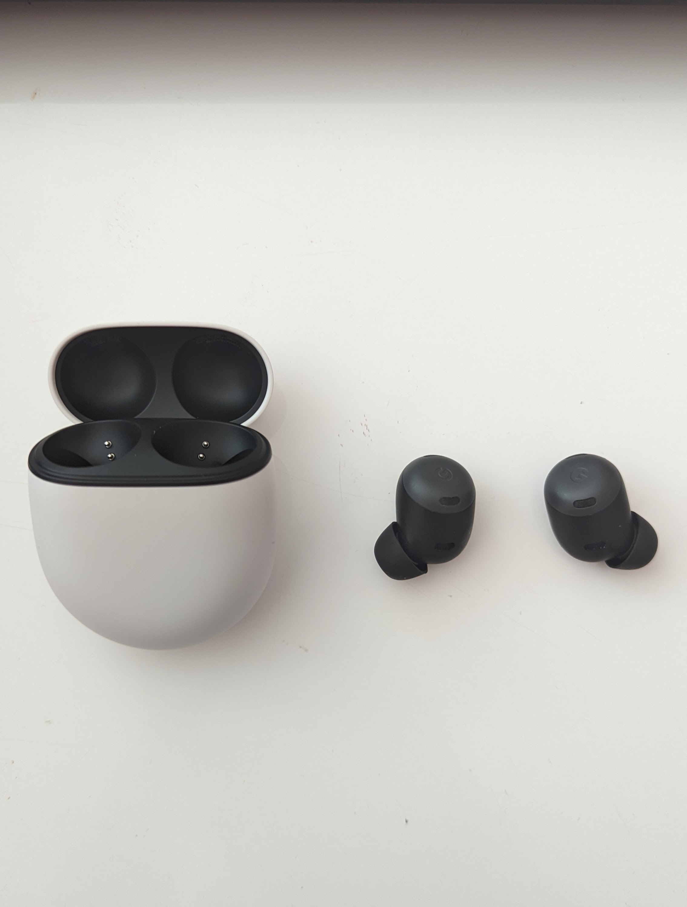 The Pixel Buds Pro case open with earbuds to the side.