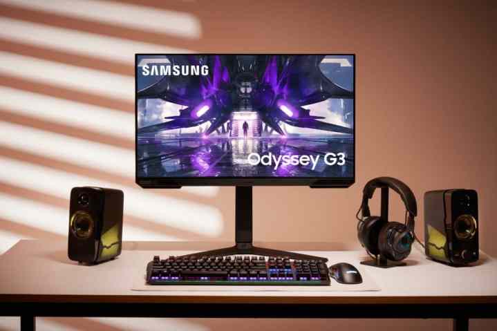 Samsung Odyssey G3 gaming monitor on desk with keyboard and headset.
