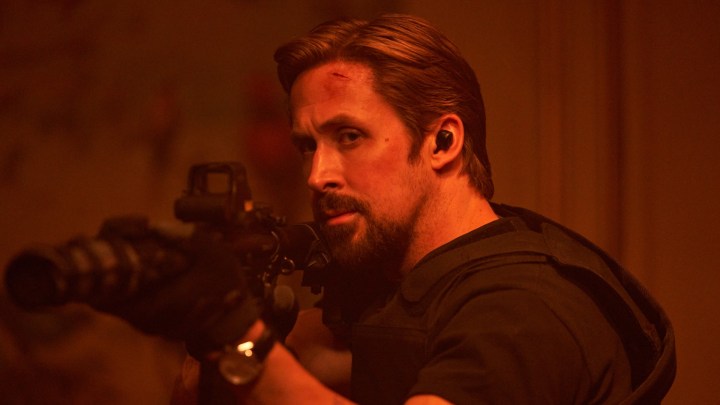 Ryan Gosling aims a big gun in the Netflix action movie The Gray Man.