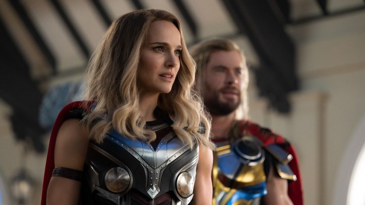 Natalie Portman and Chris Hemsworth pose as Thors in Thor: Love and Thunder..