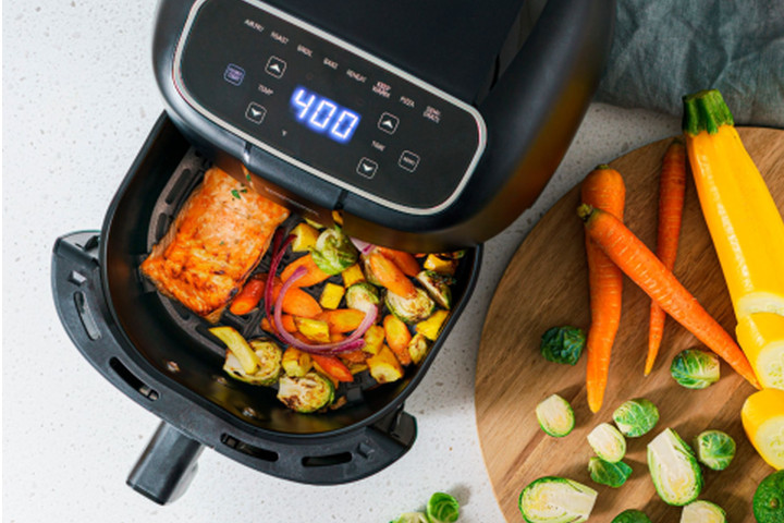 The Bella Pro Series Digital Air Fryer with a home-cooked meal inside.