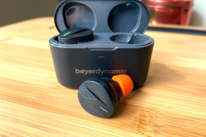 Beyerdynamic Free Byrd in front of the charging case.