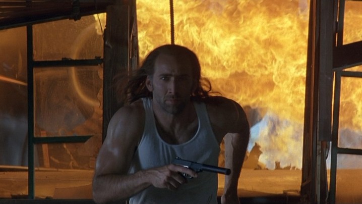Nicolas Cage as Cameron Poe running away from an explosion in Con Air.