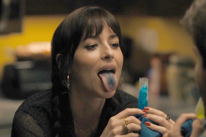 Dakota Johnson stickes her tongue out in Cha Cha Real Smooth.