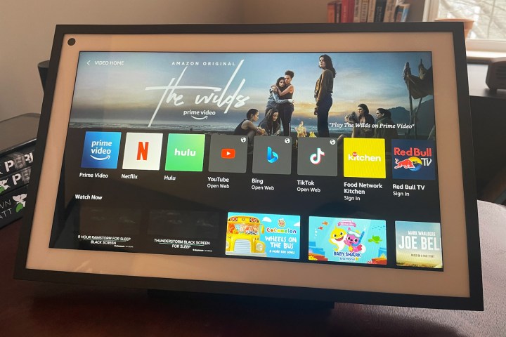 An Echo Show 15 device sits on a desk with the streaming options showing.