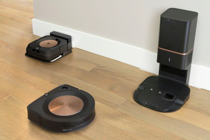 The iRobot Roomba S9+ on a hardwood floor with the Roomba Braava robot mop.