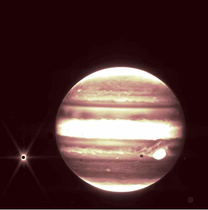 Jupiter, center, and its moon Europa, left, are seen through the James Webb Space Telescope’s NIRCam instrument 2.12 micron filter.