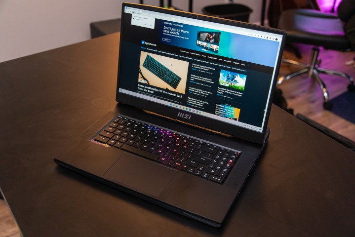 MSI GT77 Titan with the Digital Trends website up sitting on a table.