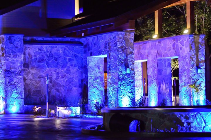 Novostella colored floodlights turning a patio blue. 