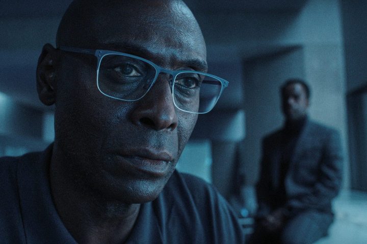 Lance Reddick stares at a scene from the Resident Evil series on Netflix.