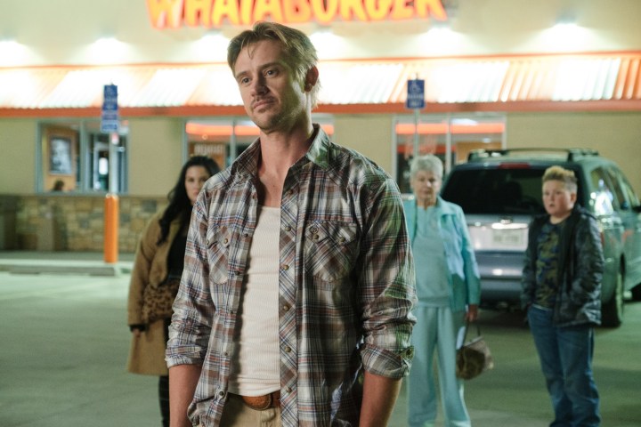Boyd Holbrook stands in a parking lot in Vengeance.