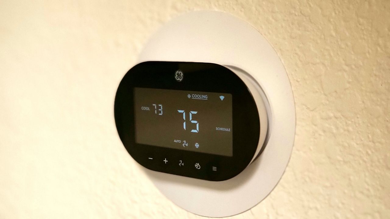 Cync Thermostat installed on a white wall.
