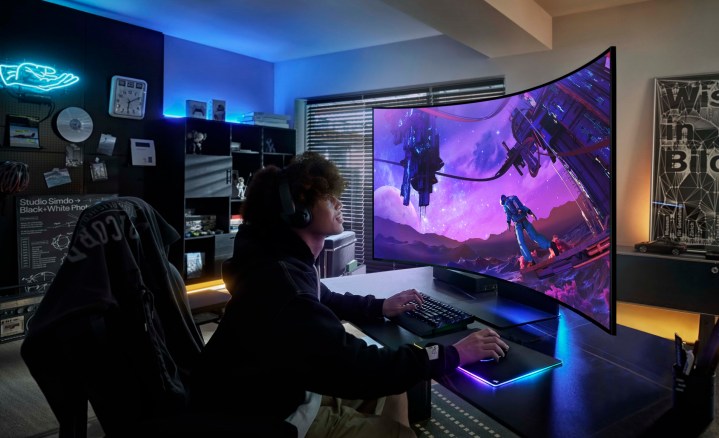 A gamer sits in front of the Samsung Odyssey ARK monitor.