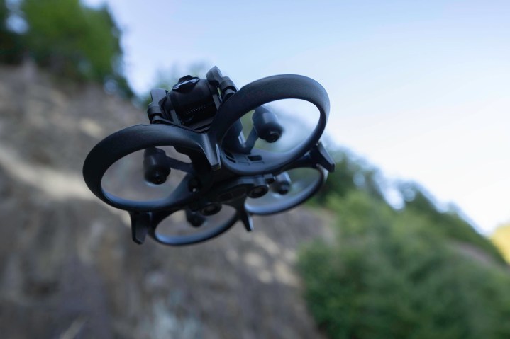 The DJI Avata flying beside a cliff.