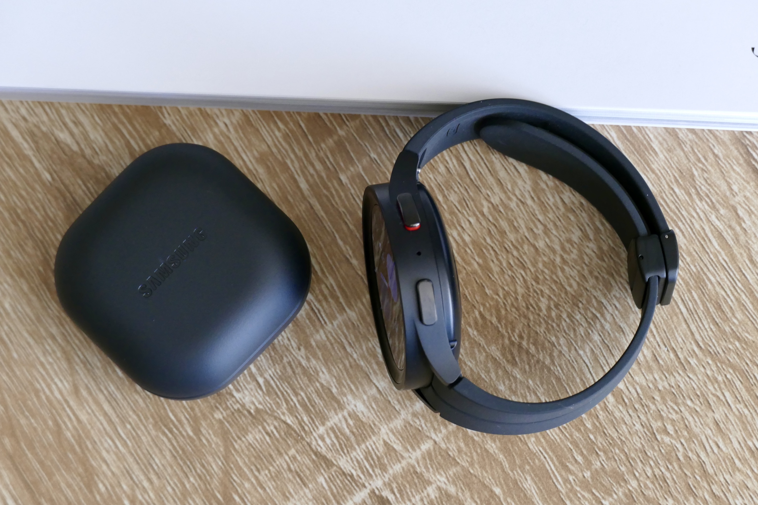 The Galaxy Watch 5 Pro seen from the side with the Galaxy Buds2 Pro alongside.
