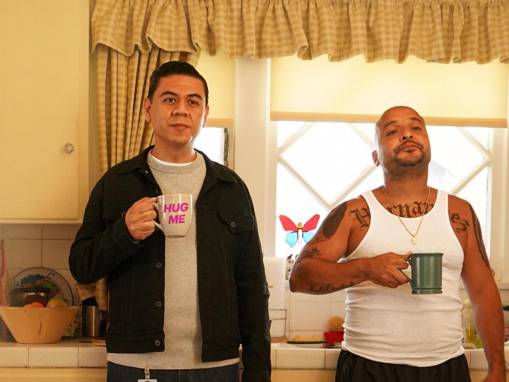 Julio e Luis de This Fool em pé na cozinha com canecas de café.