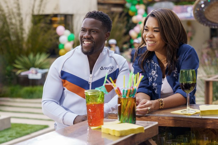 Kevin Hart and Regina Hall stand at a bar together in Netflix's Me Time.