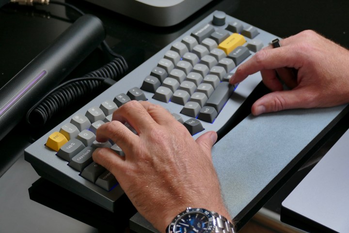 Man typing on the Keychron Q8.