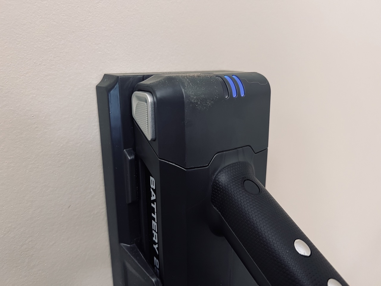 The Levoit VortexIQ 40 charging on its wall mount.