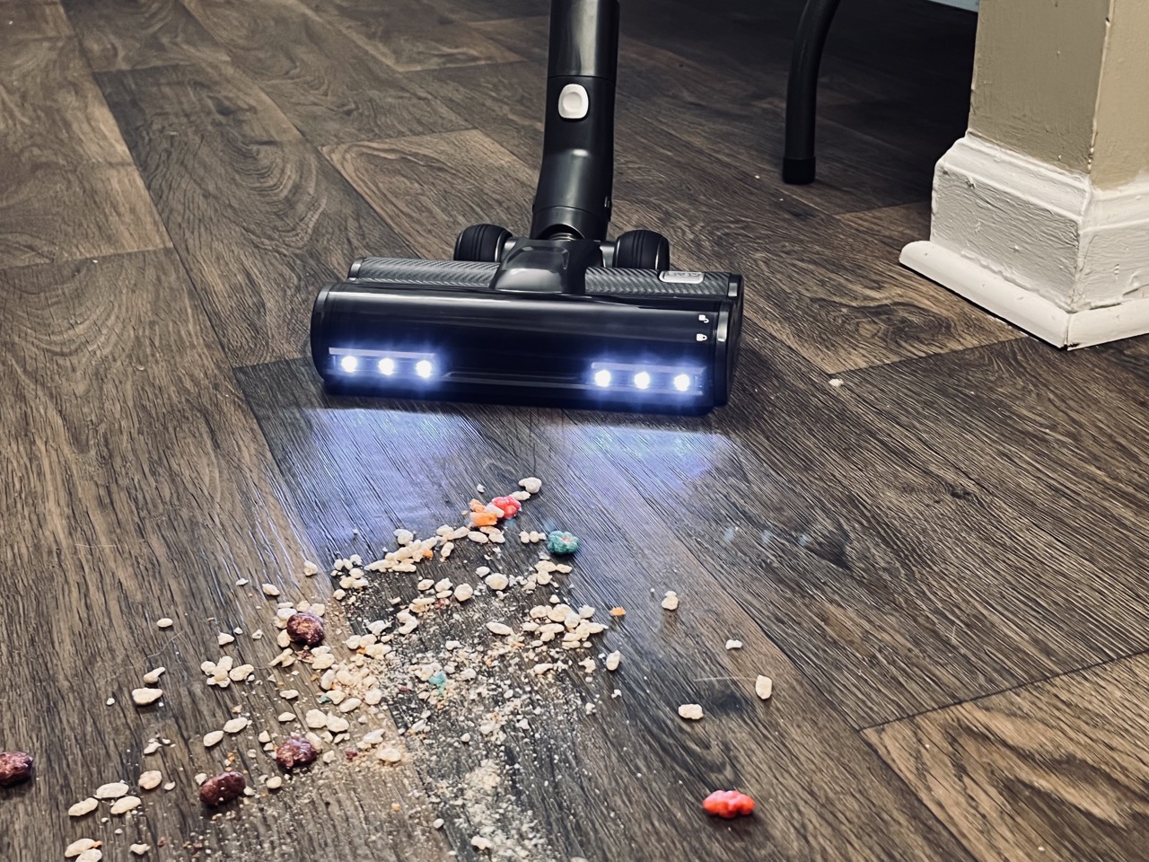The Levoit VortexIQ 40 suctioning cereal on the floor. 