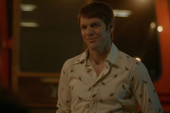 Jake Lacy creepily smiling in a scene from A Friend of the Family.