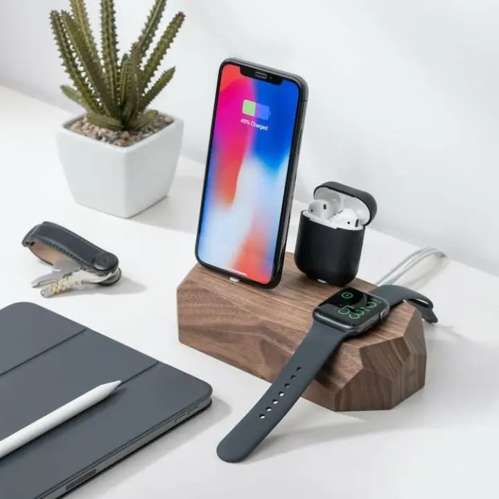 Oakywood Triple Dock - iPhone, Apple Watch, AirPods charger on desk with various Apple products.