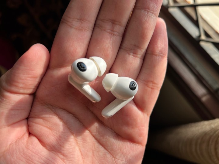 Oppo Enco X2earbuds in hand.