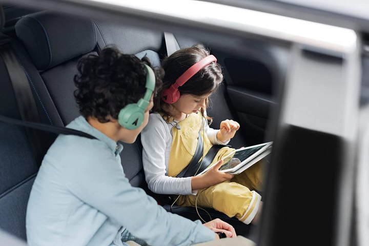 Kids wearing The Gecko headphones in the car.