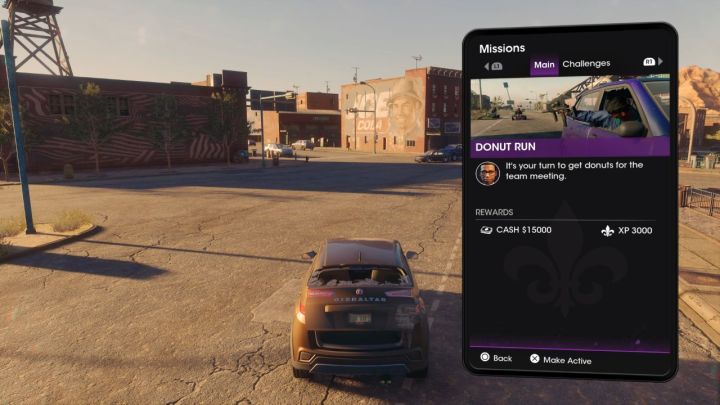 A player viewing mission details with his smartphone in Saints Row.