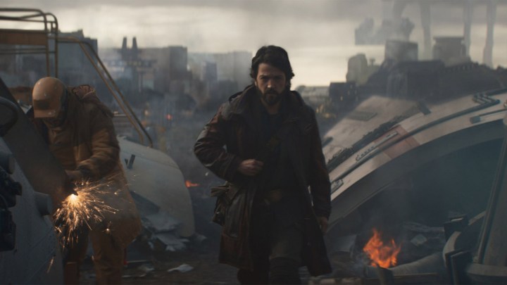 Diego Luna walking among a factory-like space in Andor.