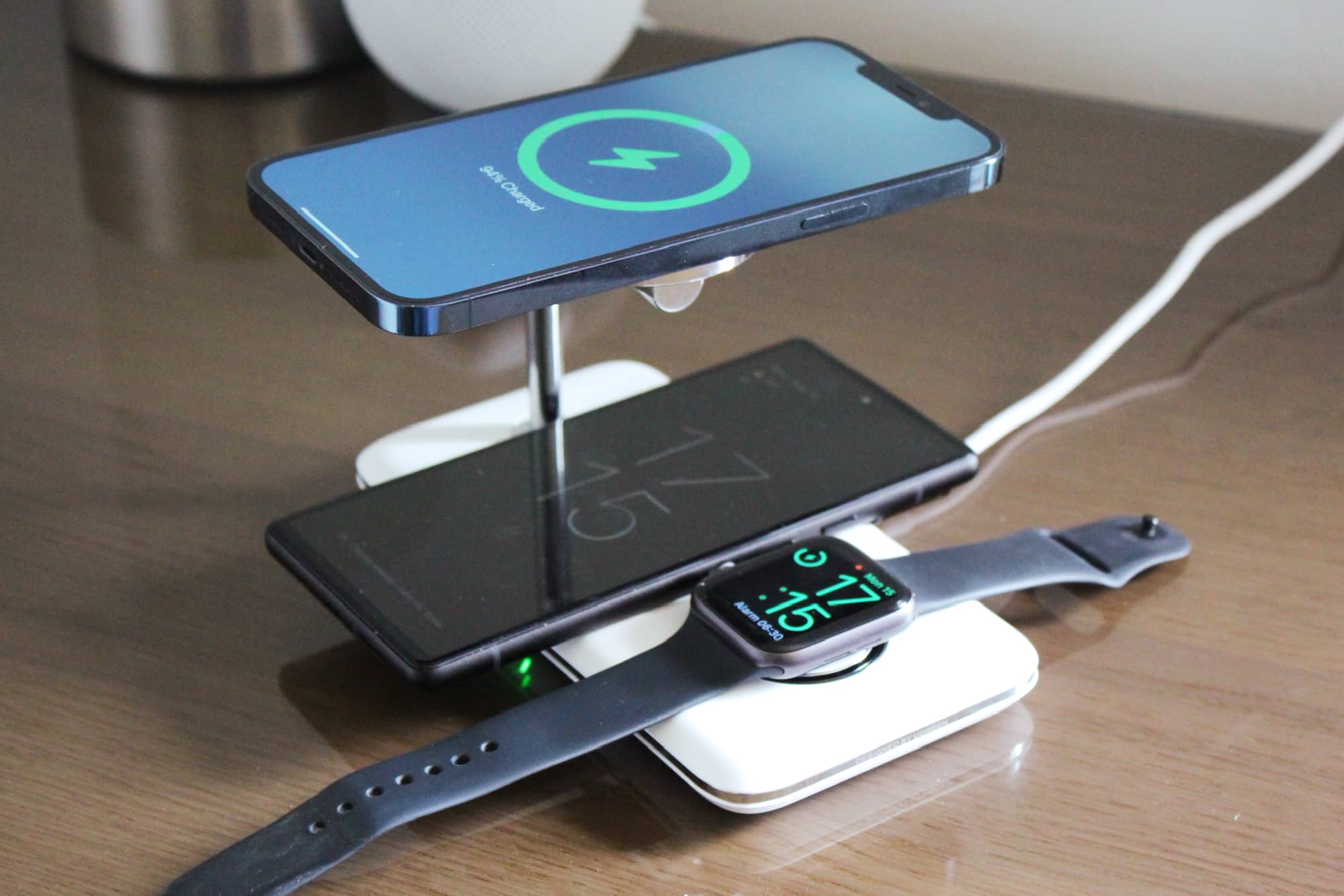iPhone 12 Pro Max and Google Pixel 6 charging in tandem alongside Apple Watch on Ugreen 3-in-1 MagSafe charging stand.