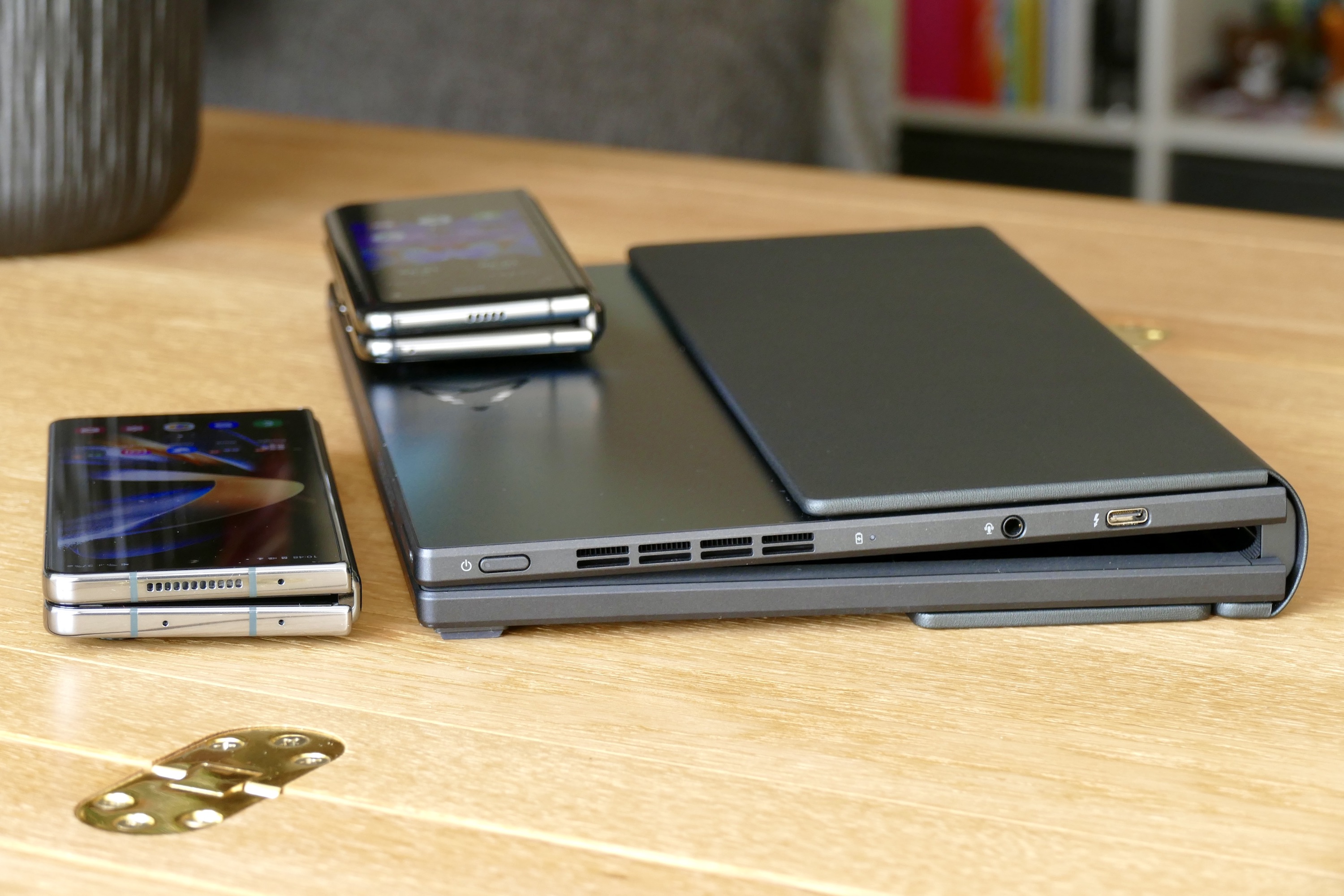 The closed Asus Zenbook Fold 17 with the Galaxy Z Fold 4 and Galaxy Fold.