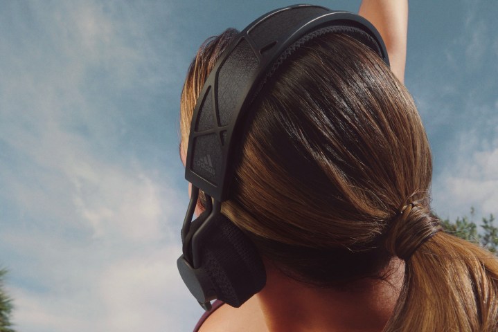 Woman wearing adidas RPT-02 SOL solar-powered headphones.