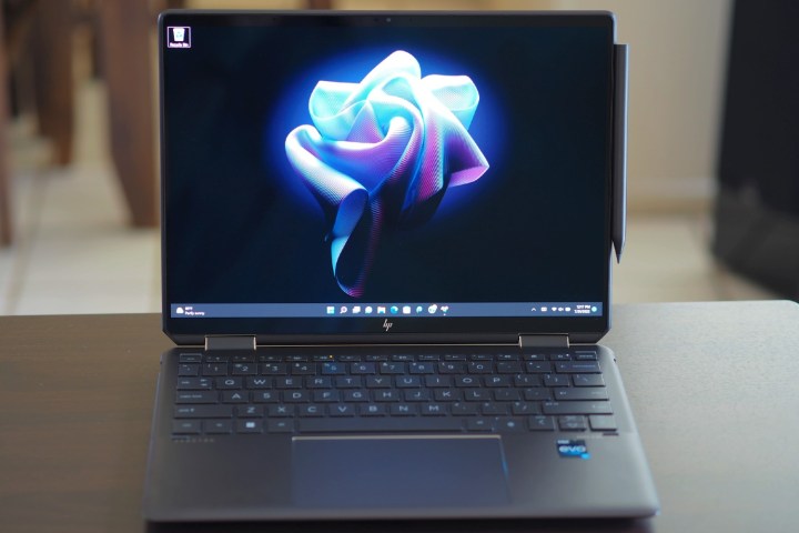 The HP Spectre x360 13.5 open on a table.