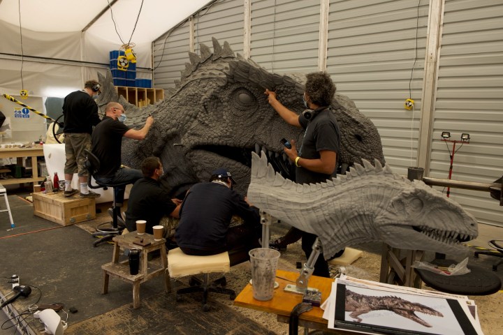Sculptors work on a model of a Giganotosaurus for Jurassic World Dominion.