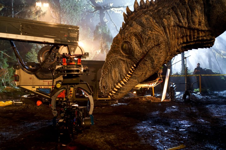 A Giganotosaurus model looms in the foreground of a scene from Jurassic World Dominion.