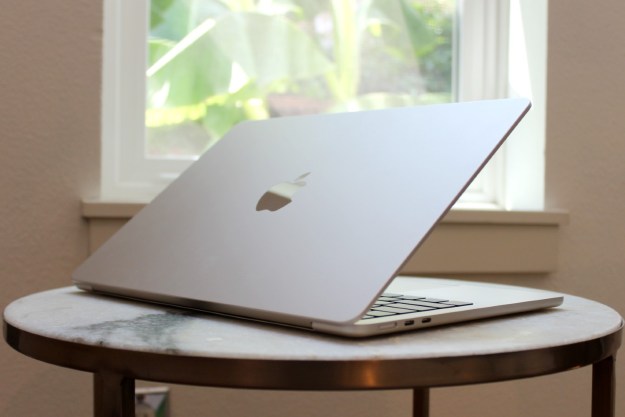 The MacBook Air on a table in front of a window.