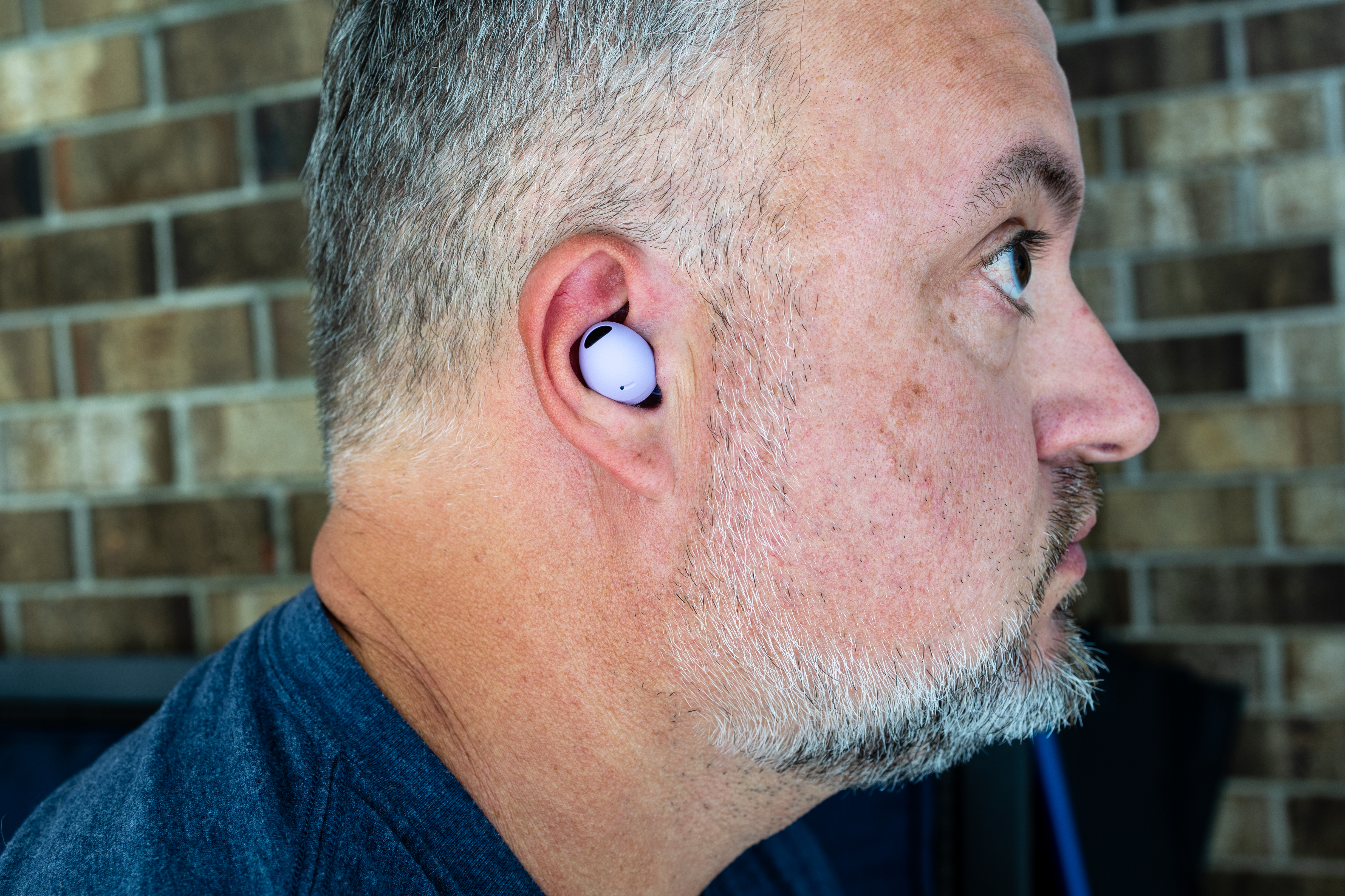 A man wearing a pair of Samsung Galaxy Buds 2 Pro.