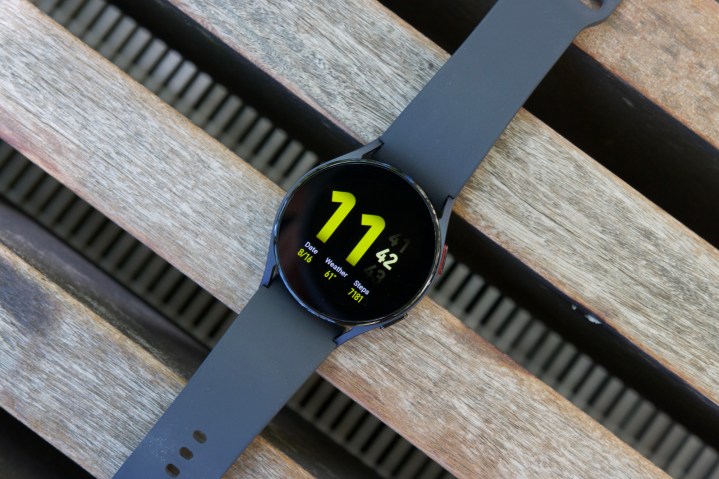 The Samsung Galaxy Watch 5 laying on a bench.