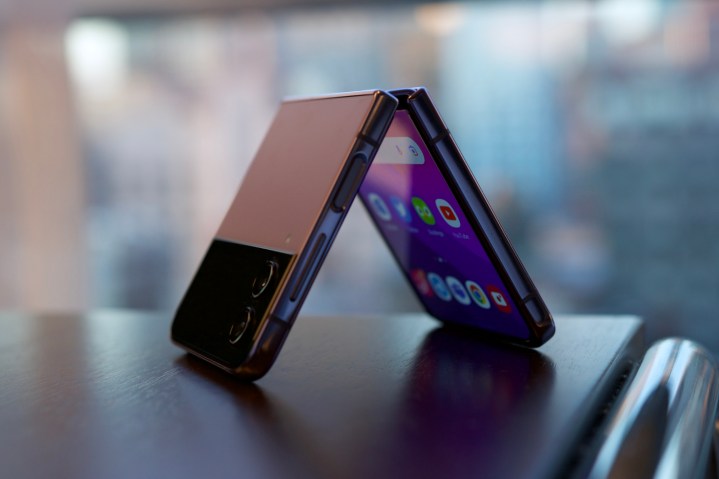 The Samsung Galaxy Z Flip 4 standing upside down on a table.