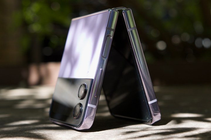 The Samsung Galaxy Z Flip 4, standing upside down while half opened up.