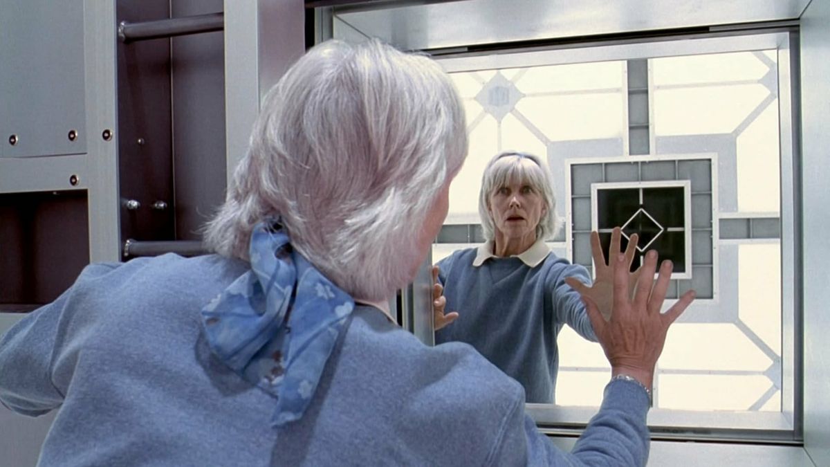 A prisoner in Cube looks at herself in a mirror imaged cube in Cube 2 Hypercube