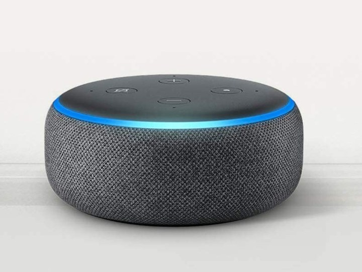 Amazon Echo Dot (3rd Gen) sitting on a light gray shelf.